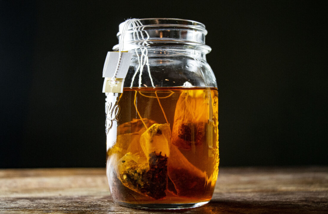 A mason jar filled with whiskey and chai tea bags